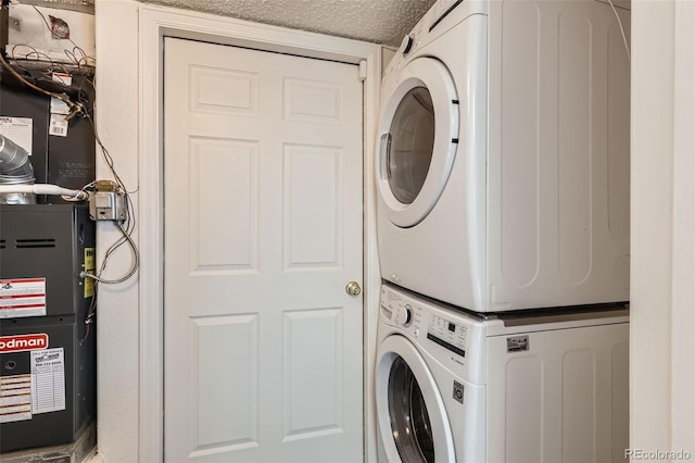 4081 Odessa St, Denver, CO 80249 - washroom with stacked washer / dryer, heating unit, and a textured ceiling