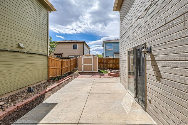 4081 Odessa St, Denver, CO 80249 - view of patio / terrace featuring a storage shed, a fenced backyard, and an outdoor structure