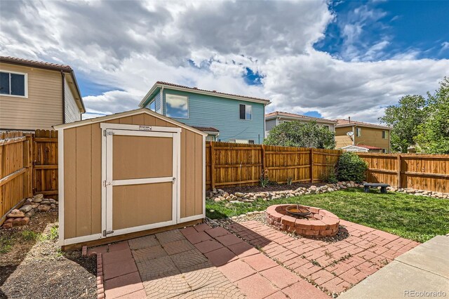 4081 Odessa St, Denver, CO 80249 - view of patio / terrace with an outdoor fire pit, a storage unit, and an outbuilding