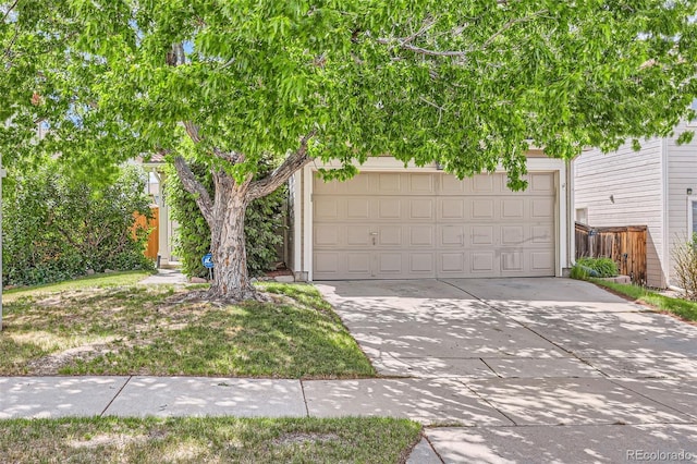 4081 Odessa St, Denver, CO 80249 - view of property hidden behind natural elements with concrete driveway and a garage