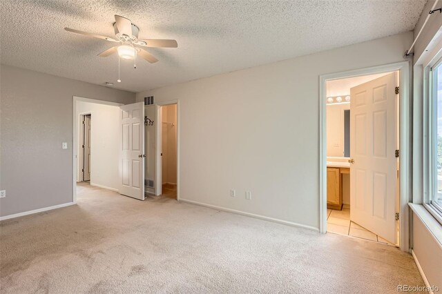 4081 Odessa St, Denver, CO 80249 - unfurnished bedroom with light carpet, a textured ceiling, ensuite bath, and baseboards