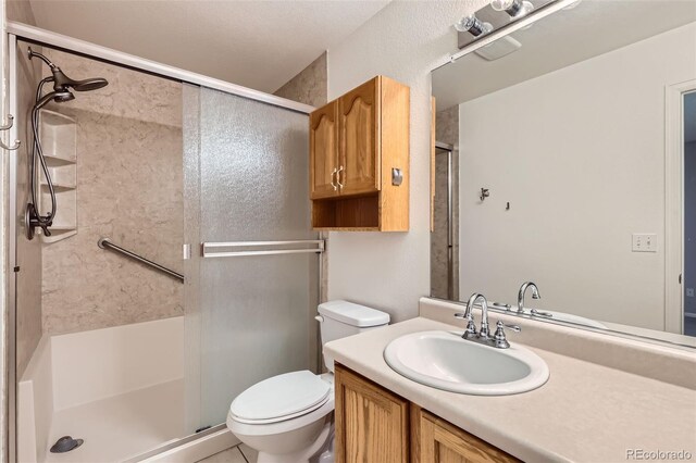 4081 Odessa St, Denver, CO 80249 - bathroom with a stall shower, toilet, and vanity