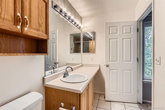 4081 Odessa St, Denver, CO 80249 - bathroom with tile patterned flooring, toilet, and vanity