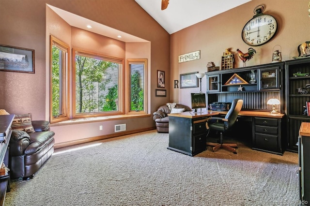 carpeted office space featuring built in desk and vaulted ceiling