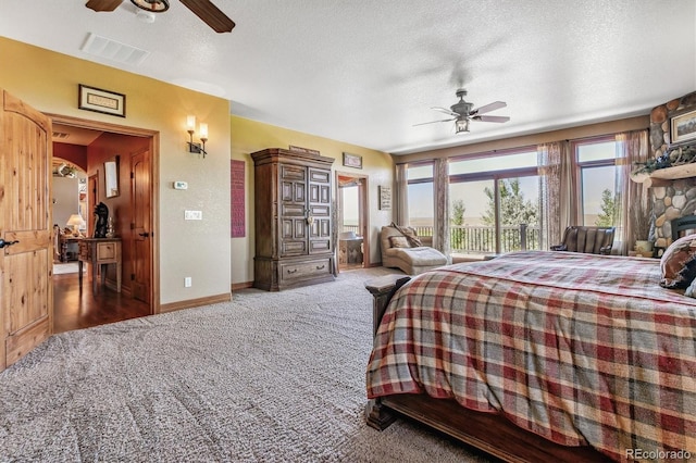 bedroom with carpet, ceiling fan, access to exterior, and a textured ceiling