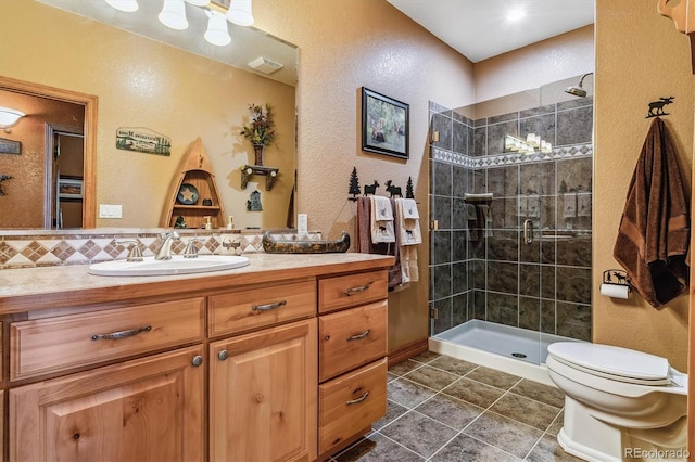 bathroom featuring vanity, toilet, and a shower with door