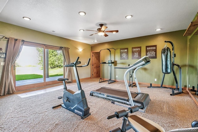 workout room with ceiling fan, carpet floors, and a textured ceiling