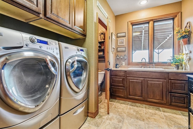 laundry room with sink, cabinets, and independent washer and dryer