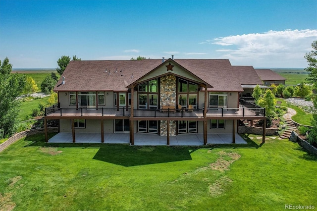 back of house with a patio and a lawn