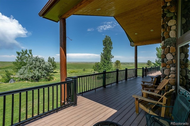 deck featuring a rural view and a lawn