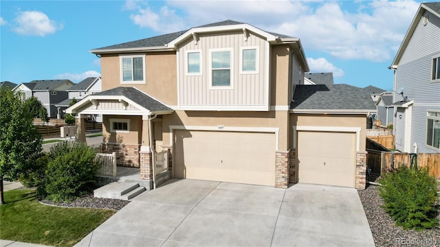 craftsman house featuring covered porch, fence, stone siding, concrete driveway, and board and batten siding