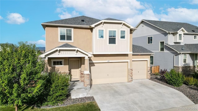 craftsman inspired home featuring a garage, concrete driveway, and stucco siding