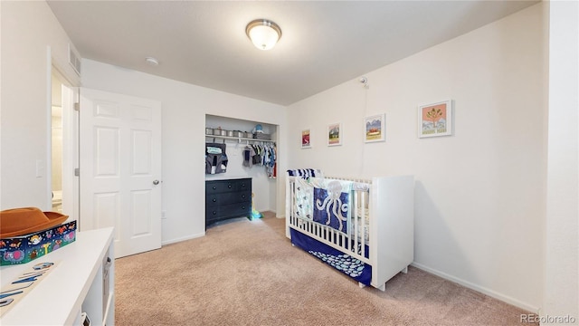 bedroom with carpet floors, a closet, visible vents, and baseboards