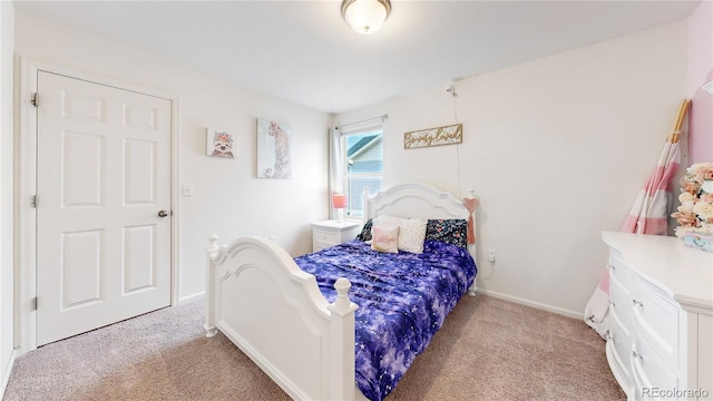 bedroom with baseboards and light colored carpet