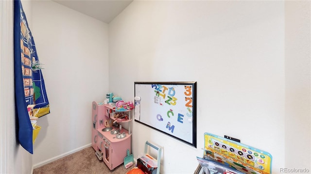 recreation room featuring carpet floors and baseboards