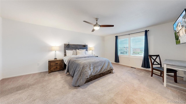 carpeted bedroom featuring ceiling fan, visible vents, and baseboards