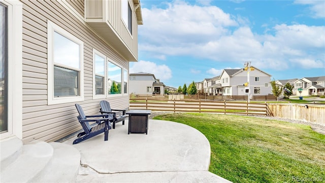 view of patio with a residential view and fence