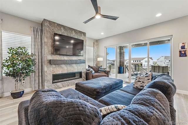 living area featuring light wood-type flooring, a fireplace, recessed lighting, and ceiling fan