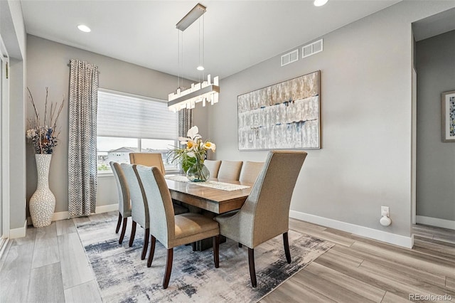 dining space with recessed lighting, wood finished floors, visible vents, and baseboards