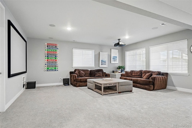 living area with visible vents, baseboards, and carpet floors
