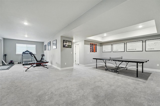 recreation room with recessed lighting, carpet floors, baseboards, and a tray ceiling