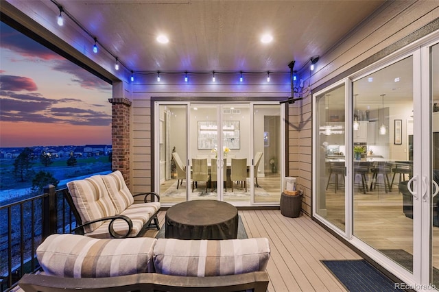 deck at dusk with outdoor dining space