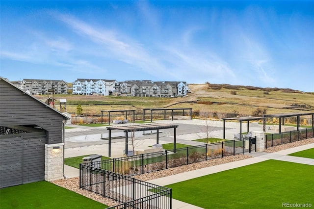 surrounding community with a yard, a residential view, and fence