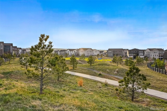 view of home's community featuring fence and a residential view