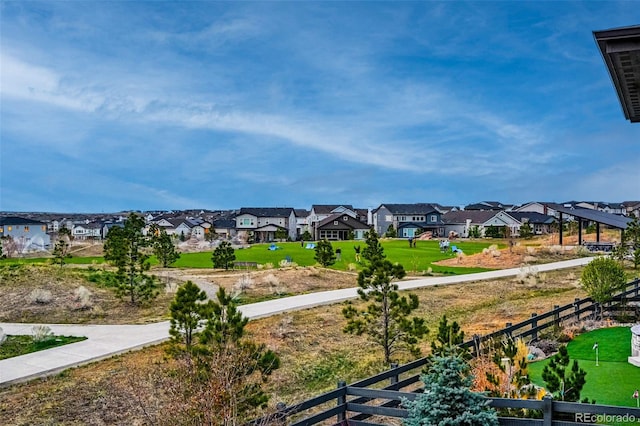 view of home's community with a residential view and fence