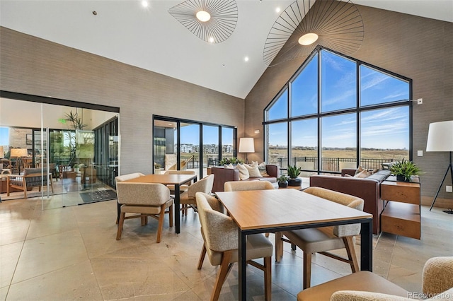 dining space with recessed lighting and high vaulted ceiling