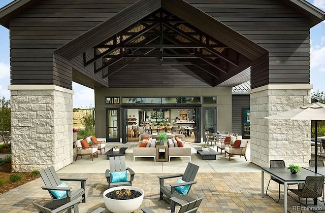 view of patio featuring an outdoor living space with a fire pit