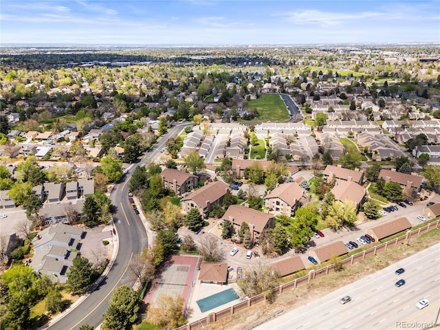 aerial view of property and surrounding area featuring nearby suburban area