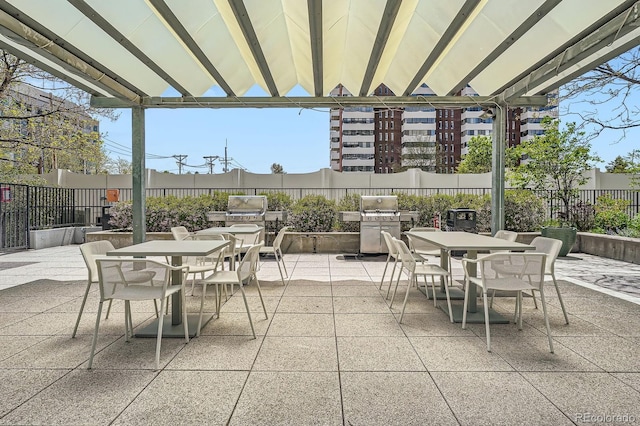 3100 E Cherry Creek S Drive 404, Denver, CO 80209 - view of patio featuring outdoor dining area and a fenced backyard