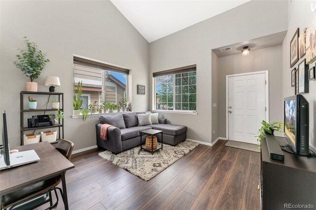 10475 E Abilene St, Commerce City, CO 80022 - living room featuring high vaulted ceiling, dark wood finished floors, an office area, and baseboards