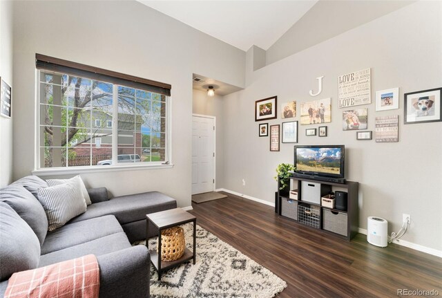 10475 E Abilene St, Commerce City, CO 80022 - living room with dark wood finished floors, baseboards, and high vaulted ceiling