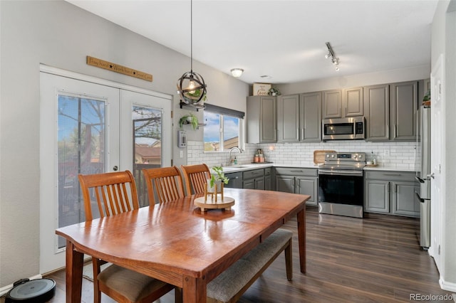 10475 E Abilene St, Commerce City, CO 80022 - kitchen with gray cabinetry, stainless steel appliances, a sink, and tasteful backsplash