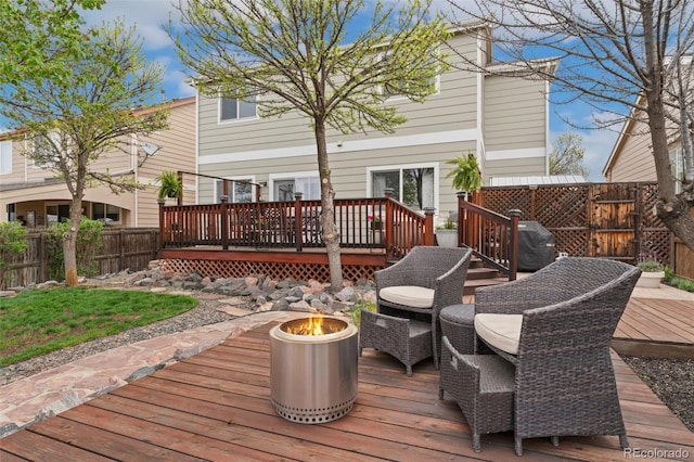 10475 E Abilene St, Commerce City, CO 80022 - wooden deck featuring an outdoor fire pit, a fenced backyard, and a grill
