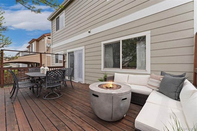 10475 E Abilene St, Commerce City, CO 80022 - wooden terrace featuring outdoor dining area and an outdoor living space with a fire pit