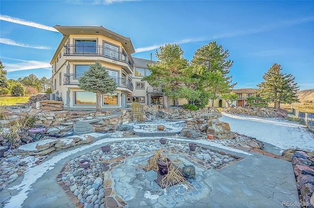 rear view of property featuring a balcony