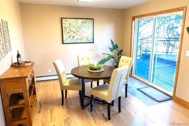 dining area with a baseboard radiator and light hardwood / wood-style floors