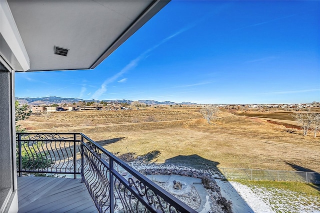 balcony featuring a rural view and a mountain view