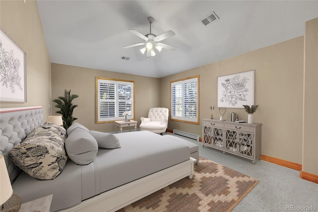 bedroom with a baseboard heating unit, ceiling fan, and carpet