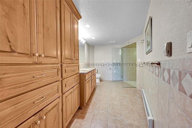 bathroom with tile walls, a baseboard heating unit, a textured ceiling, a shower, and toilet