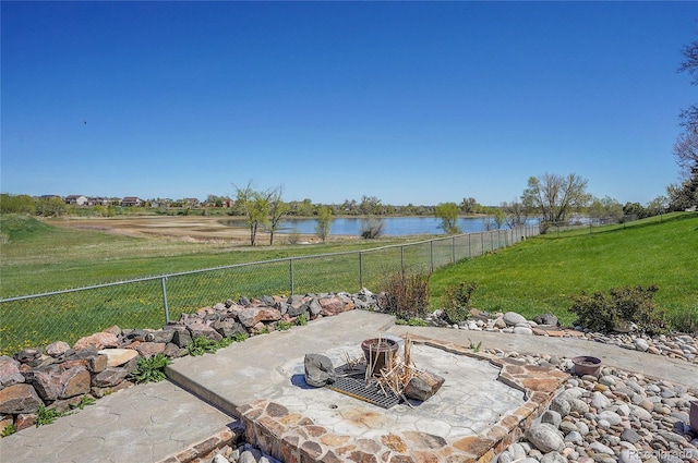 view of patio featuring a fire pit and a water view