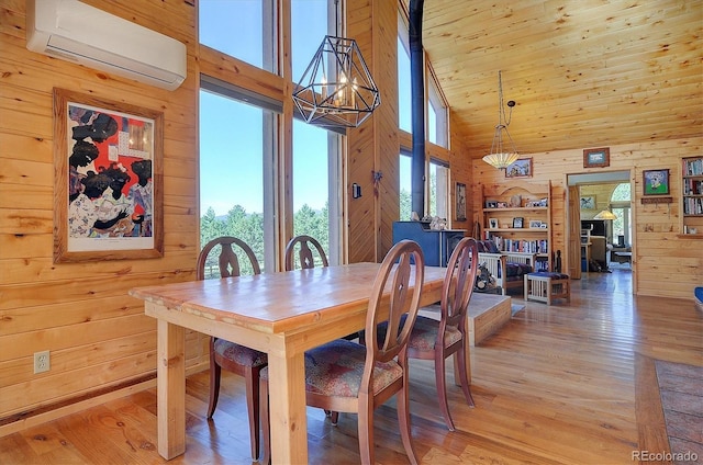 1111 Red Feather Rd, Cotopaxi, CO 81223 - dining area with a wall mounted AC, high vaulted ceiling, wooden walls, and light wood finished floors