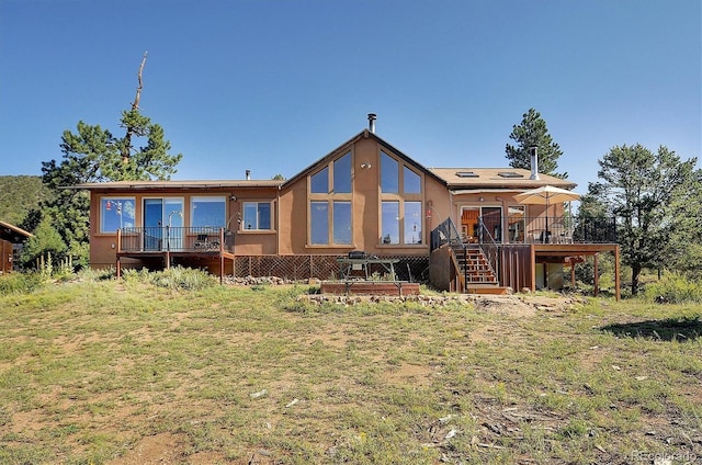 1111 Red Feather Rd, Cotopaxi, CO 81223 - back of property with stairs, a wooden deck, and stucco siding