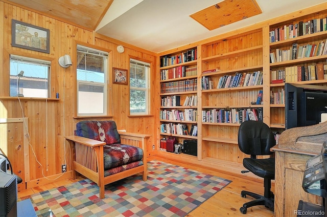 1111 Red Feather Rd, Cotopaxi, CO 81223 - sitting room featuring wood walls, wood finished floors, vaulted ceiling, and built in features