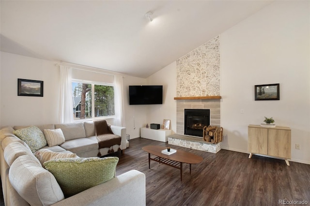 121 Aspen Dr, Woodland Park, CO 80863 - living area featuring dark wood finished floors, a fireplace, high vaulted ceiling, and baseboards