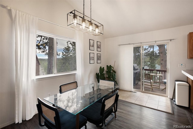 121 Aspen Dr, Woodland Park, CO 80863 - dining area featuring wood finished floors, a chandelier, and high vaulted ceiling