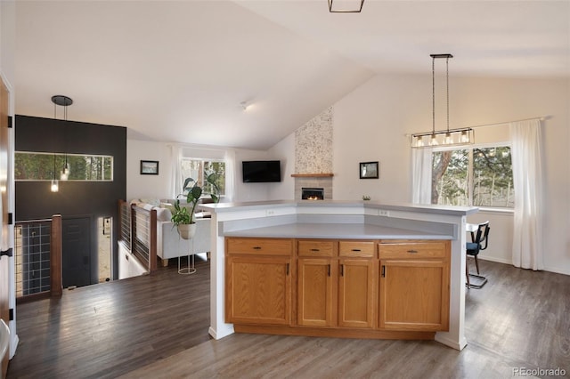 121 Aspen Dr, Woodland Park, CO 80863 - kitchen with light countertops, a fireplace, light wood-type flooring, hanging light fixtures, and high vaulted ceiling